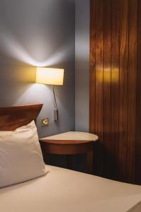 a bedroom with a bed and a lamp at Fonda Europa in Granollers