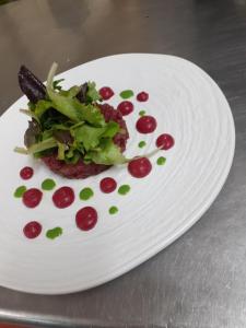 a white plate with a salad and vegetables on it at Luna Convento Copanello B&B in Stalettì