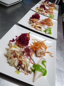 three white plates of food on a table at Luna Convento Copanello B&B in Stalettì