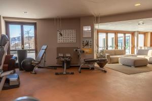 a living room with a gym with exercise equipment at Principi di Piemonte Sestriere in Sestriere