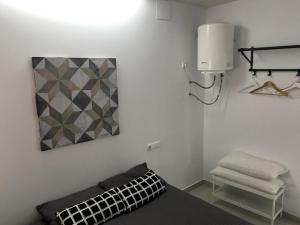 a white room with a bed and a light and a lamp at Tarifa Bed and Center in Tarifa +5 photos