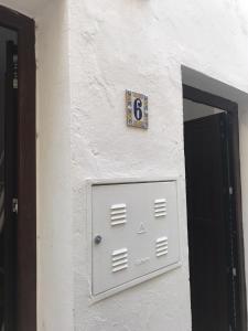 a white door with a number on the side of a building at Tarifa Bed and Center in Tarifa