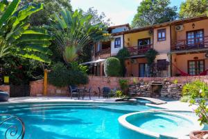 a swimming pool in front of a house at Pousada Vila Serrano in Lençóis