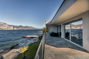 a house with a view of the water at Villa Luthien in Brenzone sul Garda