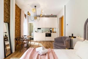 a bedroom with a bed and a living room at Apartamentos Casapalma Centro Histórico in Málaga