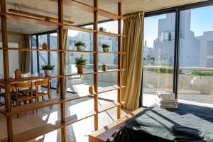 a room with a bed and a large window at Ara Homes Buenos Aires in Buenos Aires