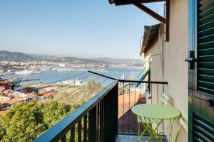 a balcony with a table and a view of a harbor at Le Viole Matte - Appartamento immerso nel Verde con Vista Mare in La Spezia