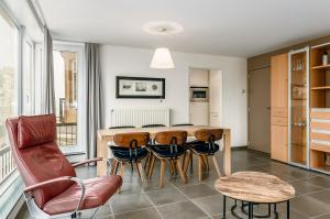 a kitchen and dining room with a table and chairs at Centre Leopold 204 in De Panne
