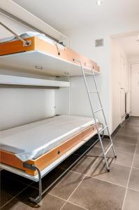 a bunk bed with a ladder in a room at Centre Leopold 204 in De Panne