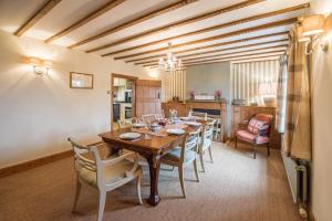 a dining room with a wooden table and chairs at 46 Ivy Cottage Air Manage Suffolk in Woodbridge