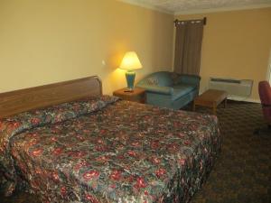 a hotel room with a bed and a couch at Executive Inn Wichita in Wichita