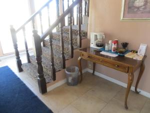 a wooden table next to a stair railing with a table at Executive Inn Wichita in Wichita