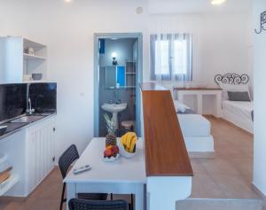 a kitchen and a living room with a table at Villa Papadakis in Hersonissos