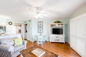 a living room with a couch and a table at Tradewinds #1008 in Orange Beach