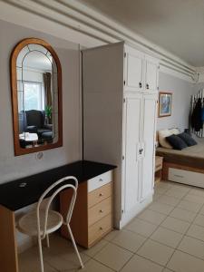 a bedroom with a desk and a bed with a mirror at Sirokkó Apartman in Balatonfüred