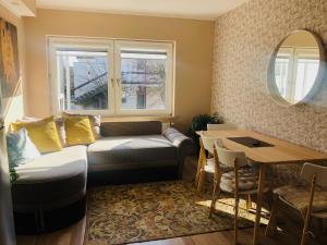 a living room with a couch and a table at Vila Romantika in Palanga