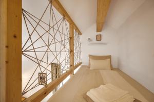 a room with a bed in the middle of a room at die Tauplitz Lodges - Mountain view Lodge A11 by AA Holiday Homes in Tauplitz