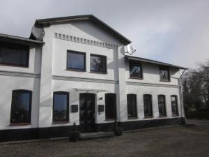 a white building with black windows and doors at Ferienwohnung Birkwang in Wanderup