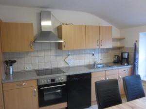 a kitchen with a sink and a stove top oven at Ferienwohnung Birkwang in Wanderup