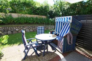 a table and chairs sitting on a patio at Anne in Wenningstedt