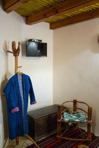 a room with a bed and a tv on a wall at Amulet Hotel in Bukhara