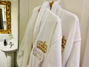 a bathroom with white towels on a rack next to a sink at Lairds Lodge Inverness in Inverness +47 photos