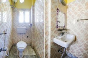 コルカタにあるHoliday Rental Roomsのバスルーム(洗面台、トイレ、鏡付)