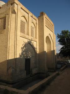 a large brick building with a door on it at Amulet Hotel in Bukhara