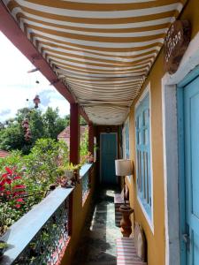 awning over a walkway on a building with flowers at Hospedaria Santa Bárbara in Rio de Janeiro