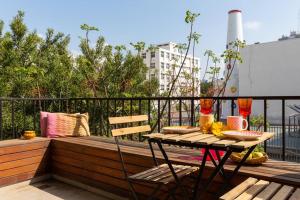 einen Tisch und einen Stuhl auf dem Balkon in der Unterkunft Frishman Dream by Five Stay in Tel Aviv