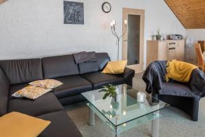 a living room with a couch and a table at Haus Hasenweide 