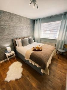 a bedroom with a bed with a tray of food on it at Parker House Beach & Golf Portrush Free parking in Portrush