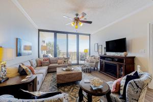 a living room with a couch and a tv at Holiday Isle in Dauphin Island