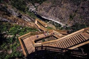 a group of people on a wooden walkway on a mountain at Quinta do Pomarinho - by RowdHouses in Arouca