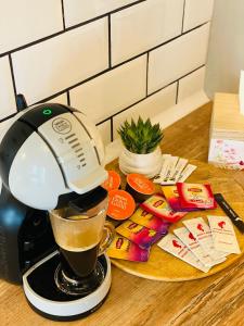 a coffee maker on a counter with a cup of coffee at Sarah Home in Hunedoara