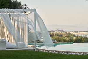 a wedding arch next to a pool with a view at The Editor's Villa - Member of Spiritual Living Corfu in Virós