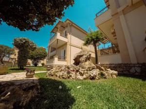 a house with a rock in front of it at Dream Drop Studios in Kyparissia