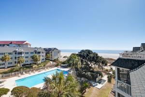 an aerial view of a resort with a swimming pool and the beach at Port O'Call C-303 in Isle of Palms