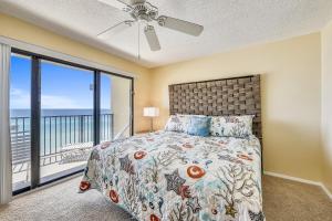a bedroom with a bed and a large window at Commodore Resort #707 by Book That Condo in Panama City Beach +67 photos