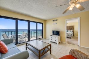 a living room with a view of the ocean at Commodore Resort #707 by Book That Condo in Panama City Beach