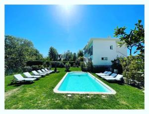 a swimming pool with lounge chairs and a building at Villa Louise-Rose in Villeneuve-Loubet