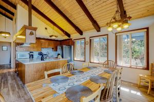 a dining room with a table and a kitchen at Rockaway Beach House in Rockaway Beach