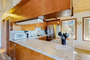 a kitchen with a counter top with a microwave at Rockaway Beach House in Rockaway Beach +29 photos