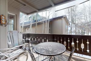 a porch with a table and chairs on a balcony at Luxury in Arrowhead in Edwards