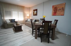 a living room with a table and a couch at Apartman Nastasijevic in Kladovo