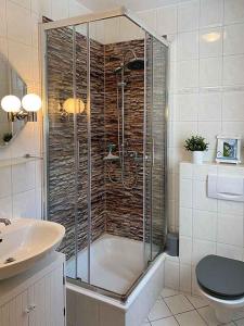 a bathroom with a shower and a sink at Ferienwohnung Lagune Göhren in Göhren