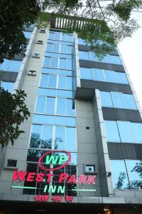 a building with a sign on the side of it at West Park Inn in Dhaka