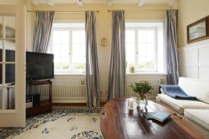 a living room with a couch and a coffee table at Dünenhaus in Hörnum