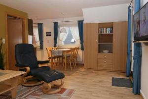 a living room with a table and chairs and a dining room at Haus Gräpel App 3 in Hörnum