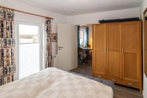 a bedroom with a bed and a large window at Haus Roseneck App.2 in Hörnum